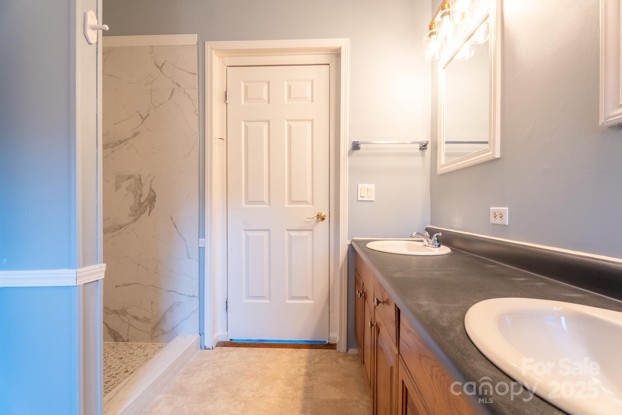 964 Lavender Road Grover, NC 28073 - Photo 14 of 26 a bathroom with a granite countertop sink and a mirror