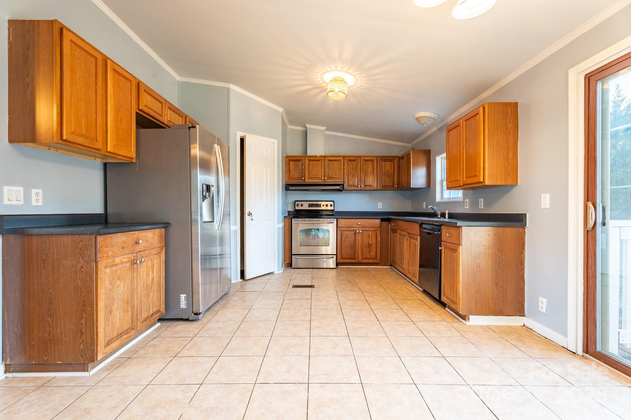 964 Lavender Road Grover, NC 28073 - Photo 5 of 26 a kitchen with stainless steel appliances granite countertop a refrigerator and a stove top oven