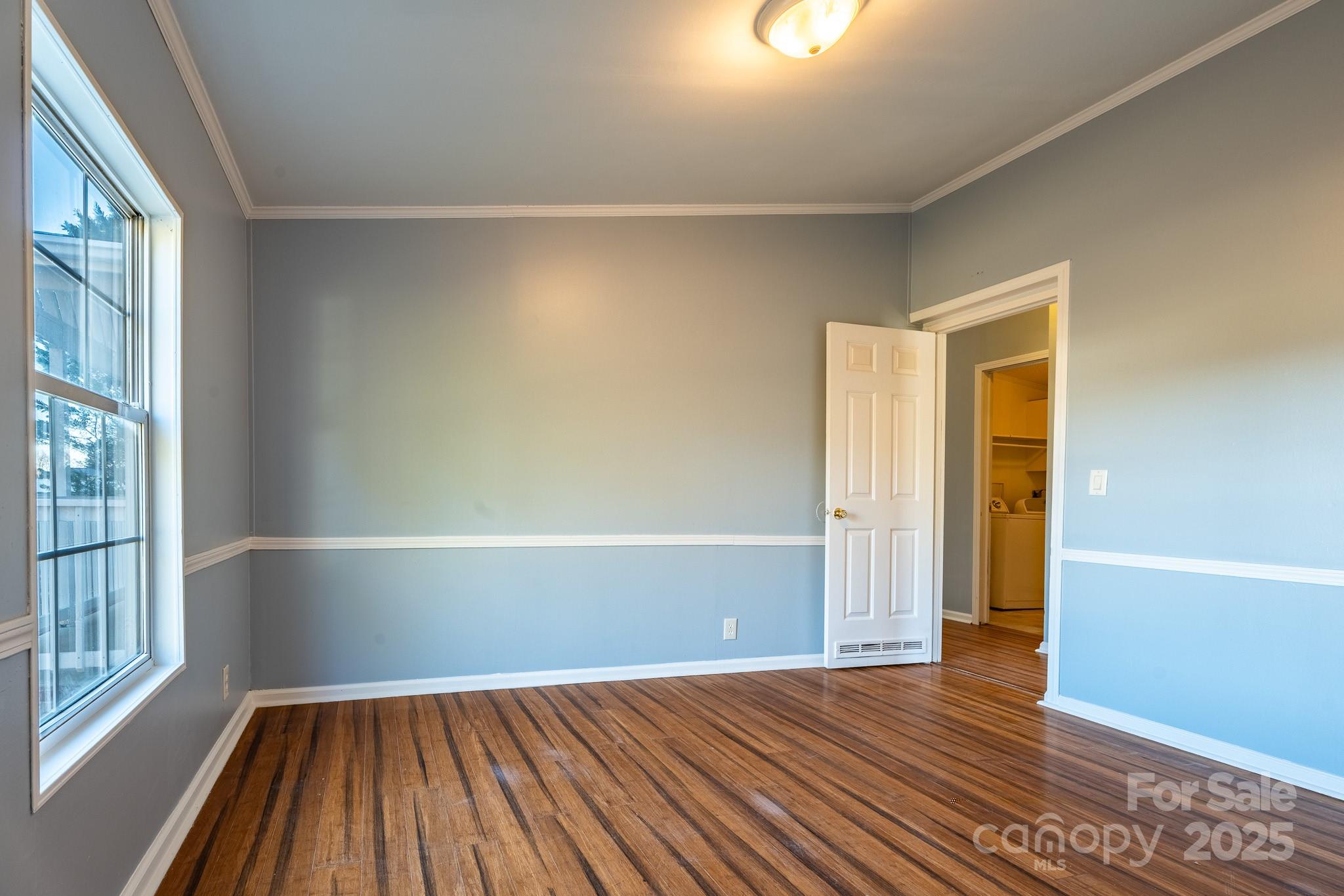 964 Lavender Road Grover, NC 28073 - Photo 7 of 26 an empty room with wooden floor and windows