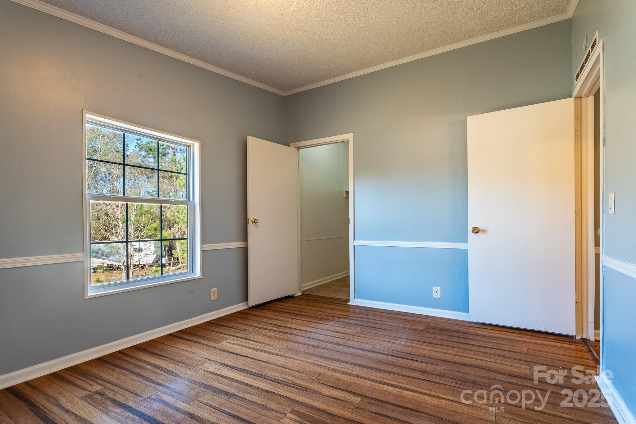 964 Lavender Road Grover, NC 28073 - Photo 9 of 26 an empty room with wooden floor and windows