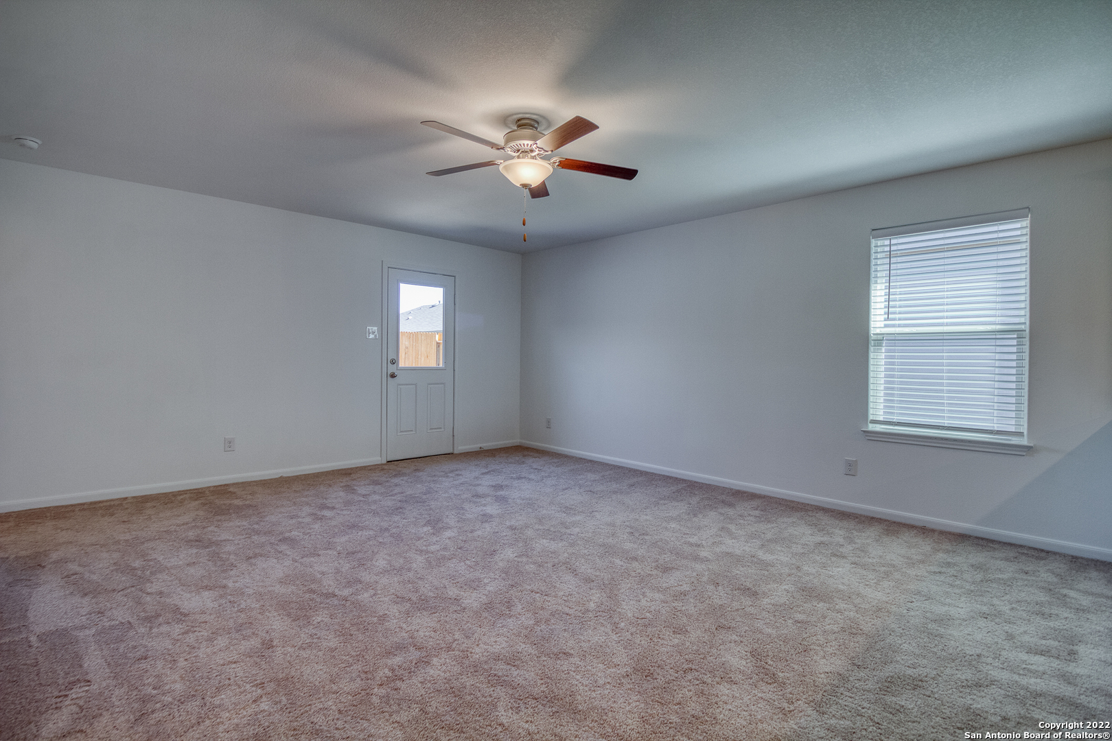 3055 Jackson Summit Converse, TX 78109 - Photo 16 of 31 an empty room with windows and fan