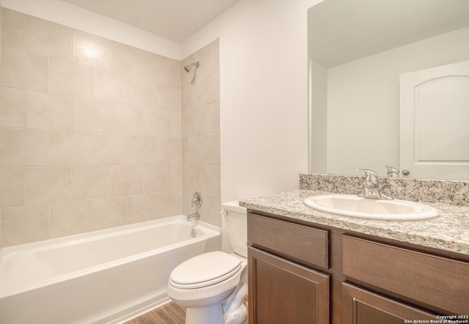 3055 Jackson Summit Converse, TX 78109 - Photo 19 of 31 a bathroom with a granite countertop sink toilet mirror and bathtub