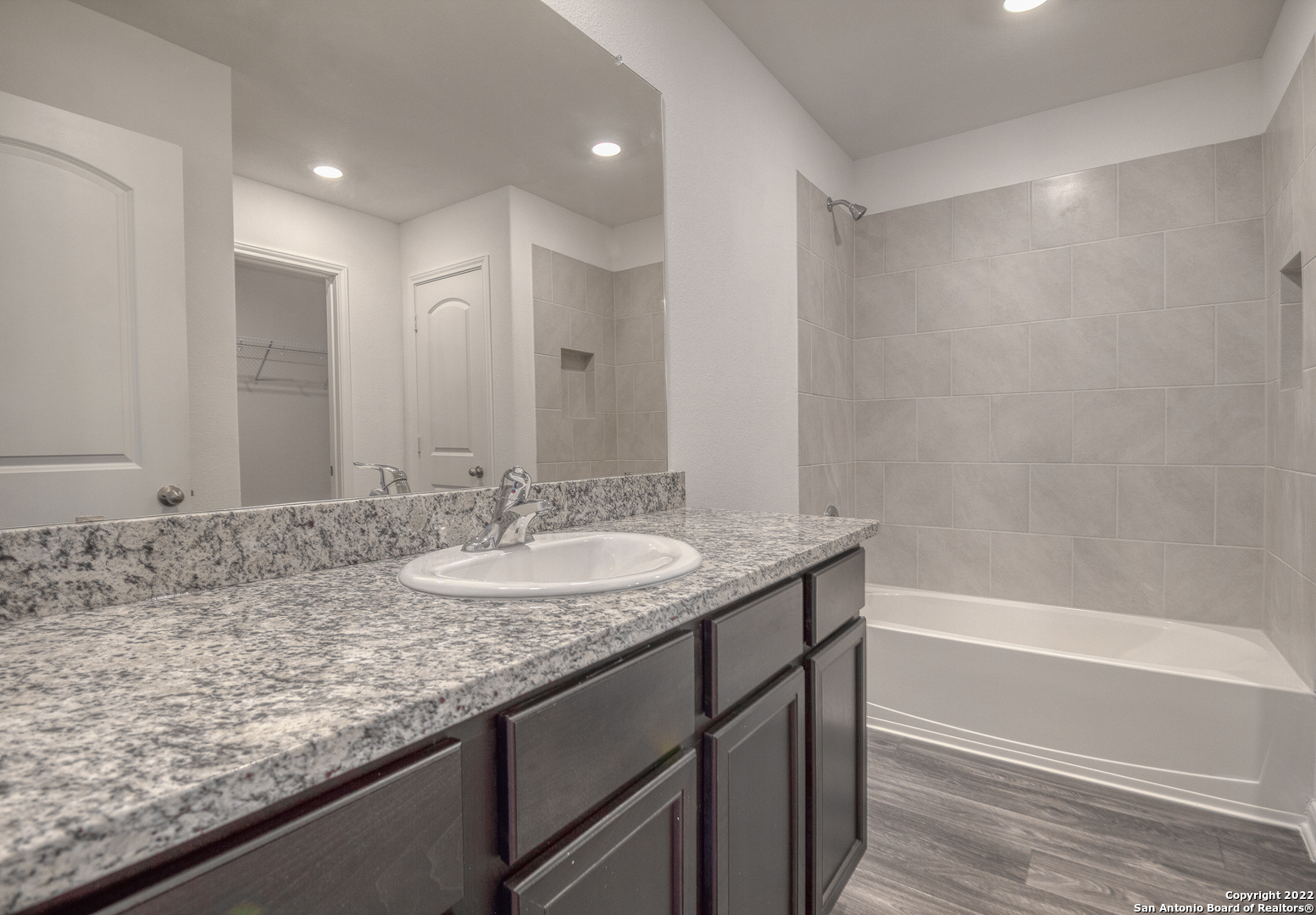 3055 Jackson Summit Converse, TX 78109 - Photo 28 of 31 a bathroom with a granite countertop sink and a mirror