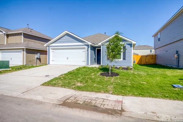 a front view of house with yard and green space