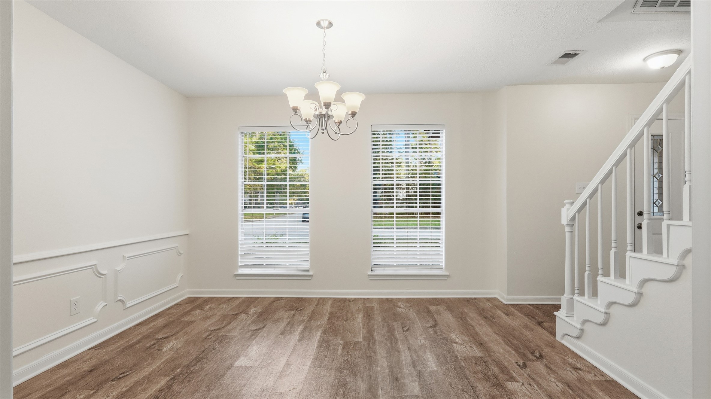 2715 Wild Ridge Drive Kingwood, TX 77339 - Photo 12 of 32 a view of an empty room with wooden floor and a window