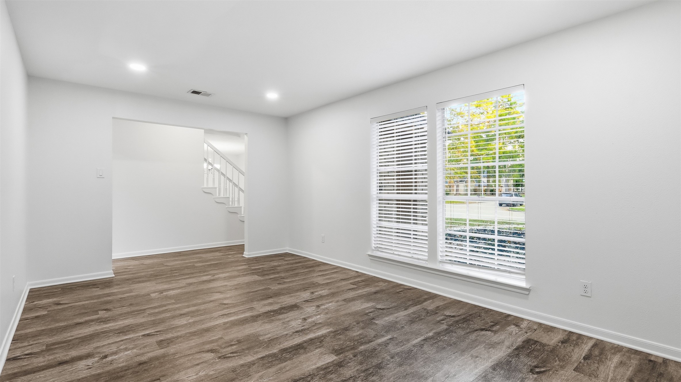 2715 Wild Ridge Drive Kingwood, TX 77339 - Photo 13 of 32 a view of an empty room with wooden floor and a window