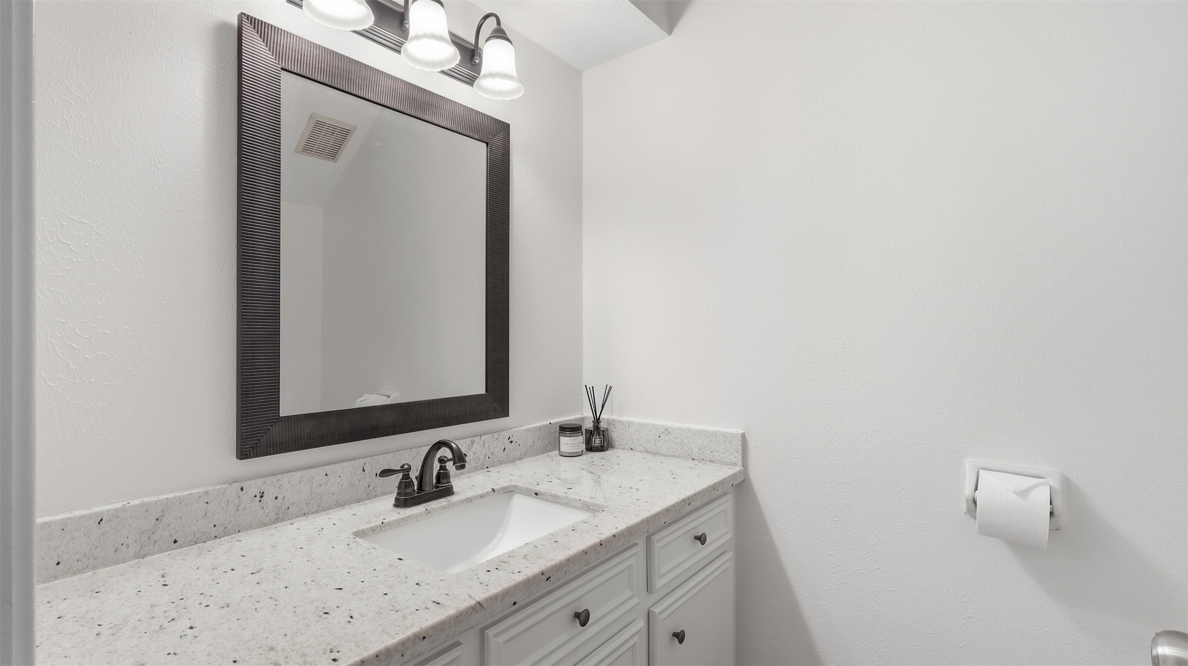 2715 Wild Ridge Drive Kingwood, TX 77339 - Photo 16 of 32 a bathroom with a granite countertop sink vanity and a mirror
