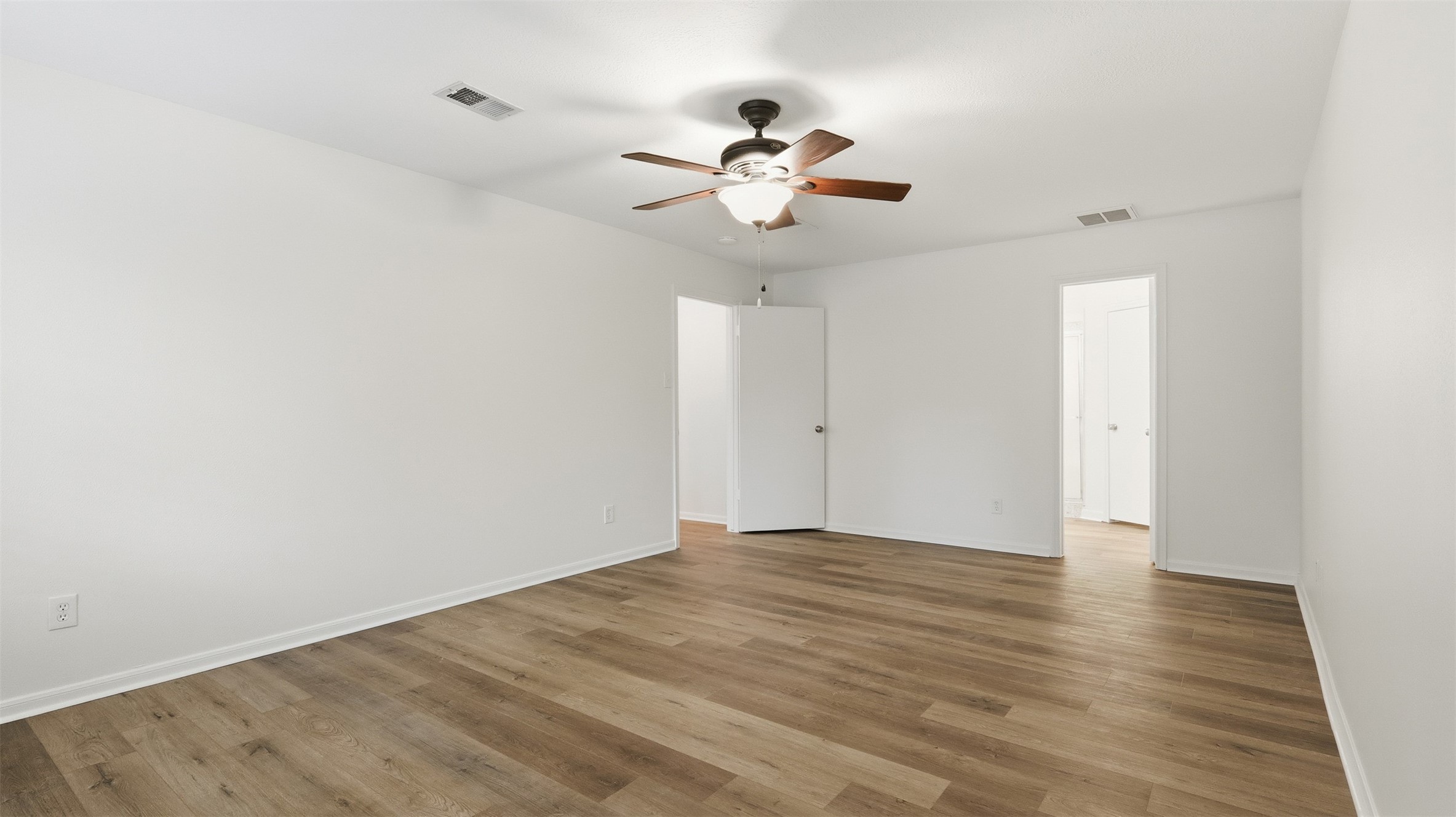 2715 Wild Ridge Drive Kingwood, TX 77339 - Photo 20 of 32 a view of an empty room with wooden floor