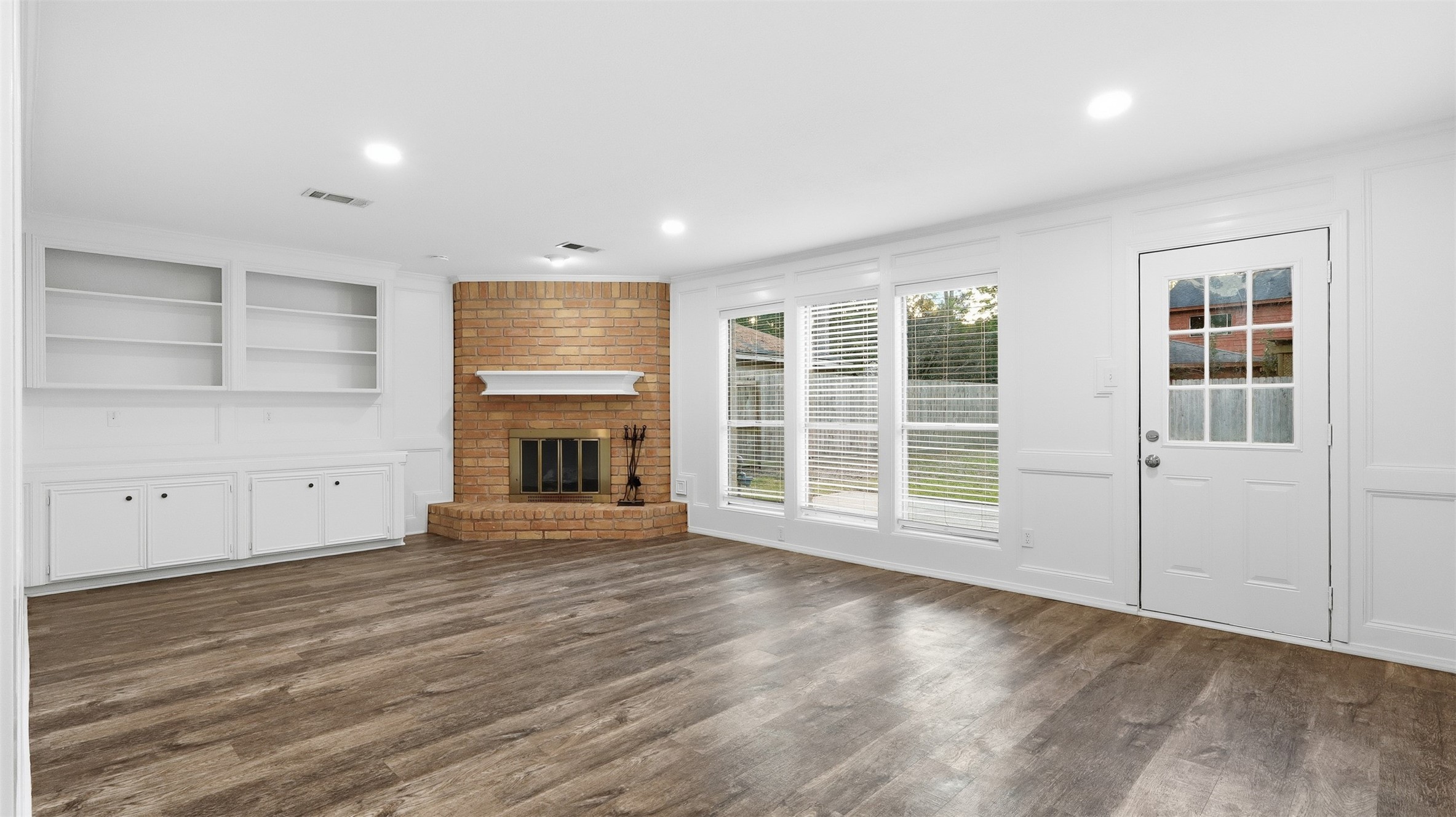 2715 Wild Ridge Drive Kingwood, TX 77339 - Photo 2 of 32 an empty room with wooden floor and windows