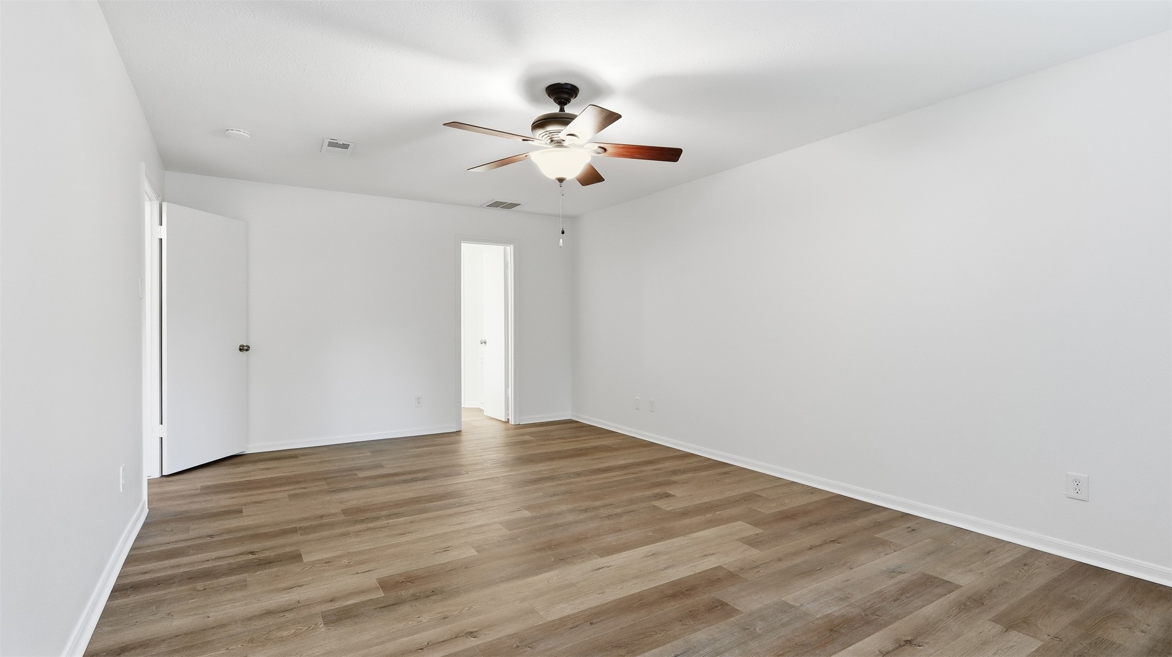 2715 Wild Ridge Drive Kingwood, TX 77339 - Photo 21 of 32 a view of an empty room with wooden floor