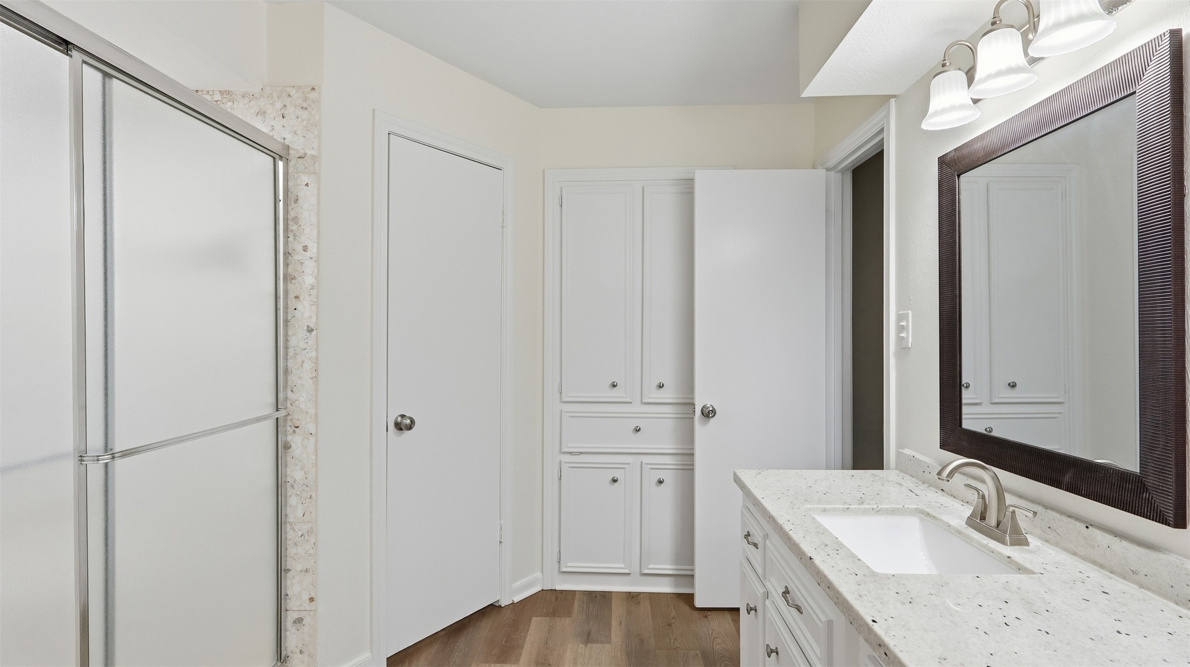 2715 Wild Ridge Drive Kingwood, TX 77339 - Photo 23 of 32 a bathroom with a granite countertop sink and a mirror