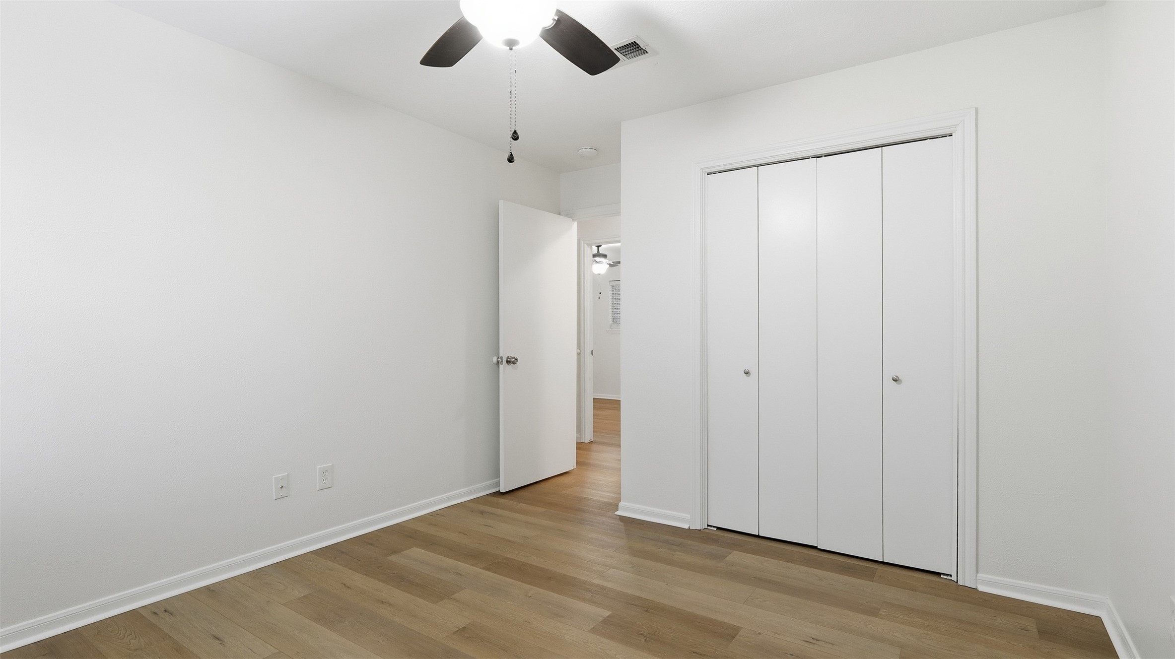 2715 Wild Ridge Drive Kingwood, TX 77339 - Photo 29 of 32 an empty room with ceiling fan and windows