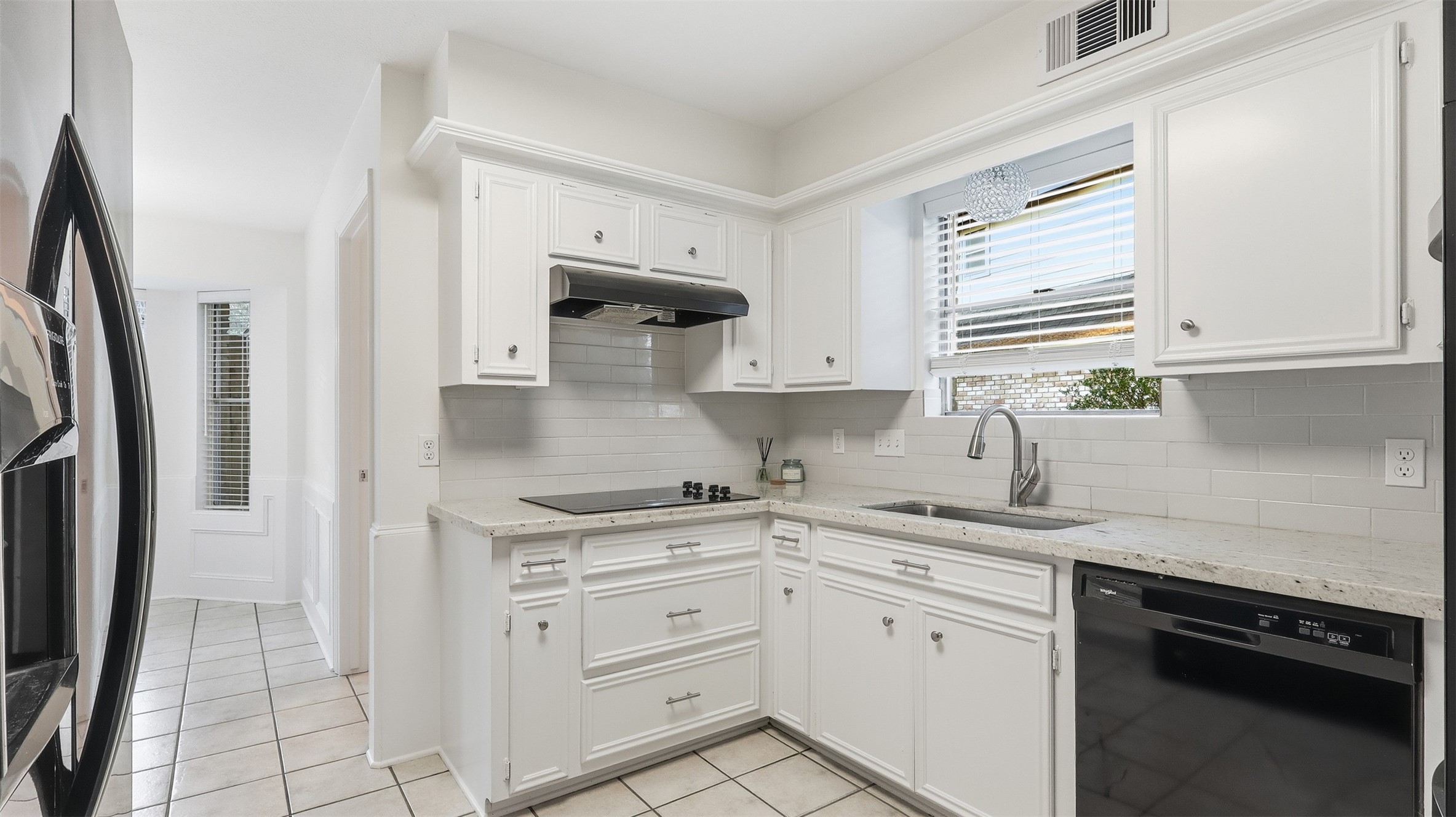 2715 Wild Ridge Drive Kingwood, TX 77339 - Photo 9 of 32 a kitchen with white cabinets and a sink