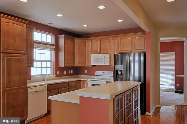 a kitchen that has a sink a stove and a refrigerator