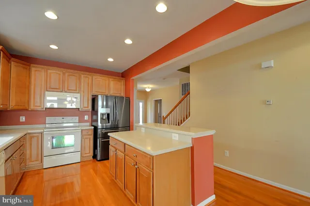 a kitchen with a sink appliances and cabinets