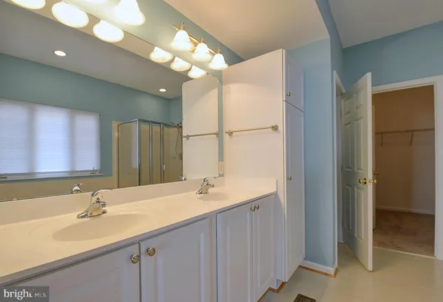 a bathroom with a double vanity sink and a mirror