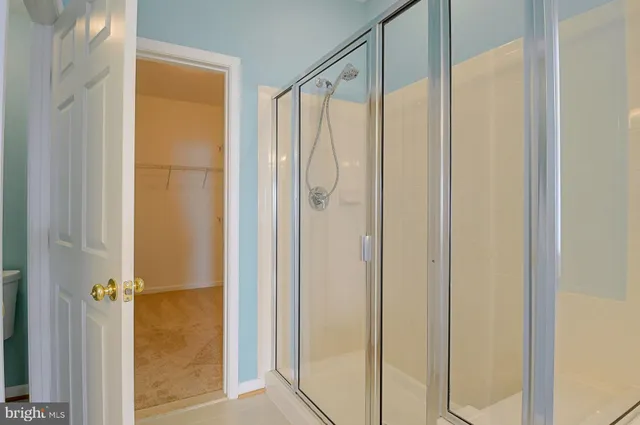 a bathroom with a glass shower door