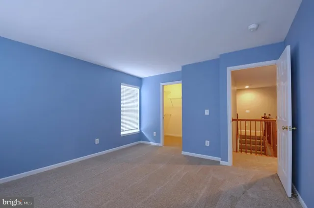 an empty room with closet and a bathroom