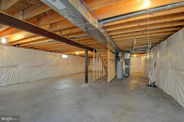 a view of empty room with wooden stairs
