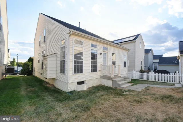 a view of house with backyard