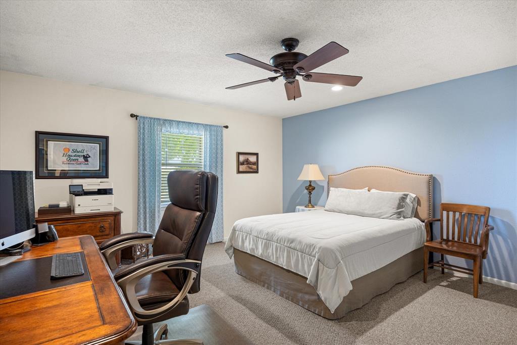17305 Highway 281 Hico, TX 76457 - Photo 12 of 28 a bedroom with a bed and a chandelier