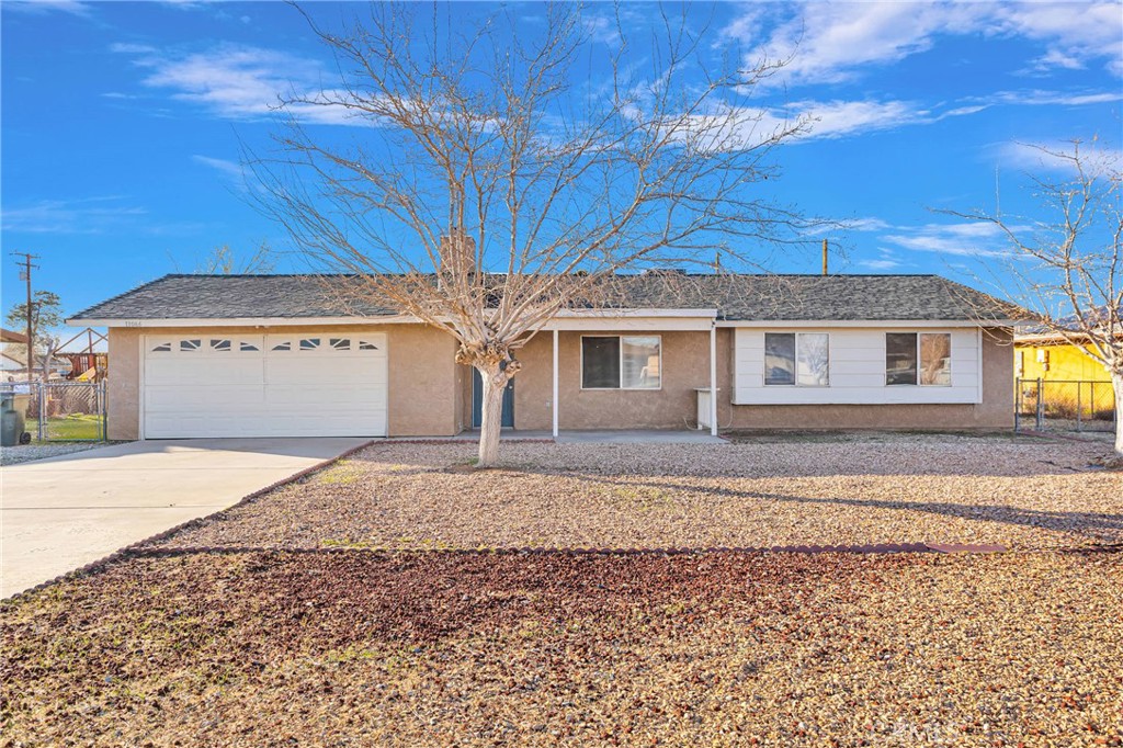 13046 Clallam Road Apple Valley, CA 92308 - Photo 1 of 1 a front view of a house with a yard and garage