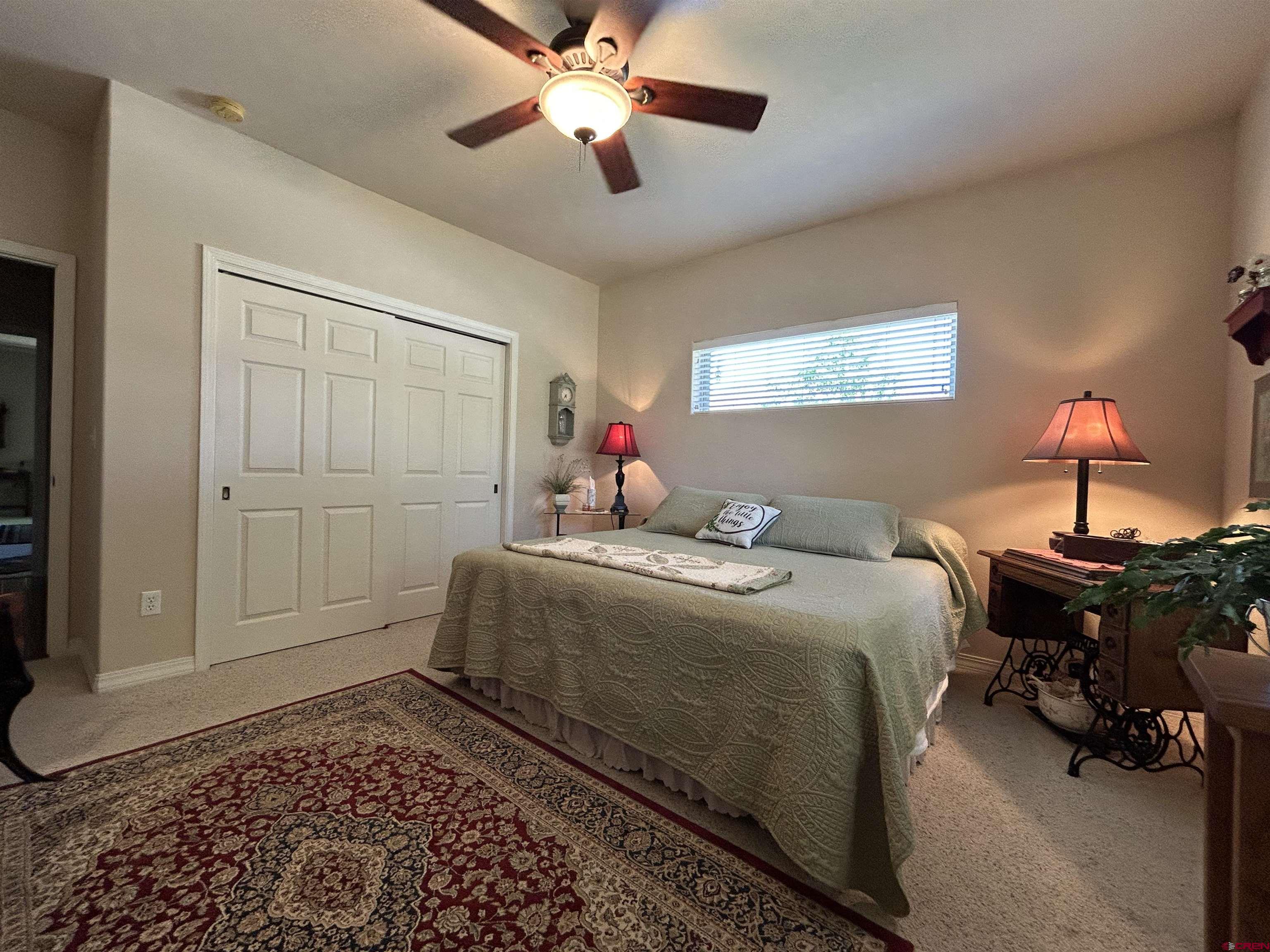850 Southeast Pinyon Street Cedaredge, CO 81413 - Photo 24 of 45 a bedroom with a bed and wooden floor