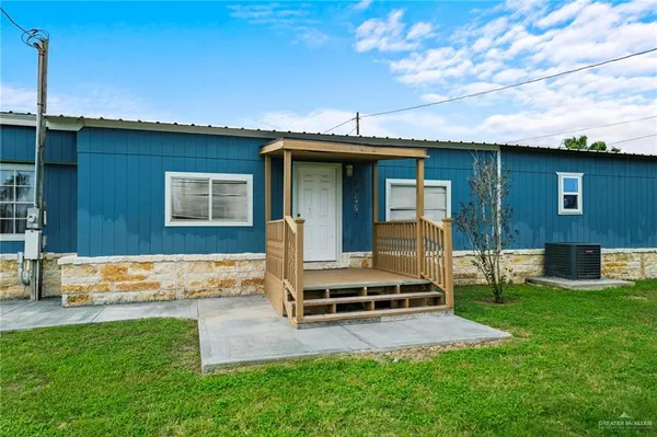 a view of a backyard with a garden and deck