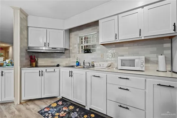 a kitchen with stainless steel appliances granite countertop a sink and cabinets