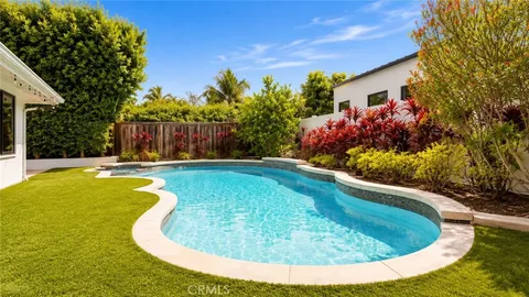 a view of a house with swimming pool and a yard