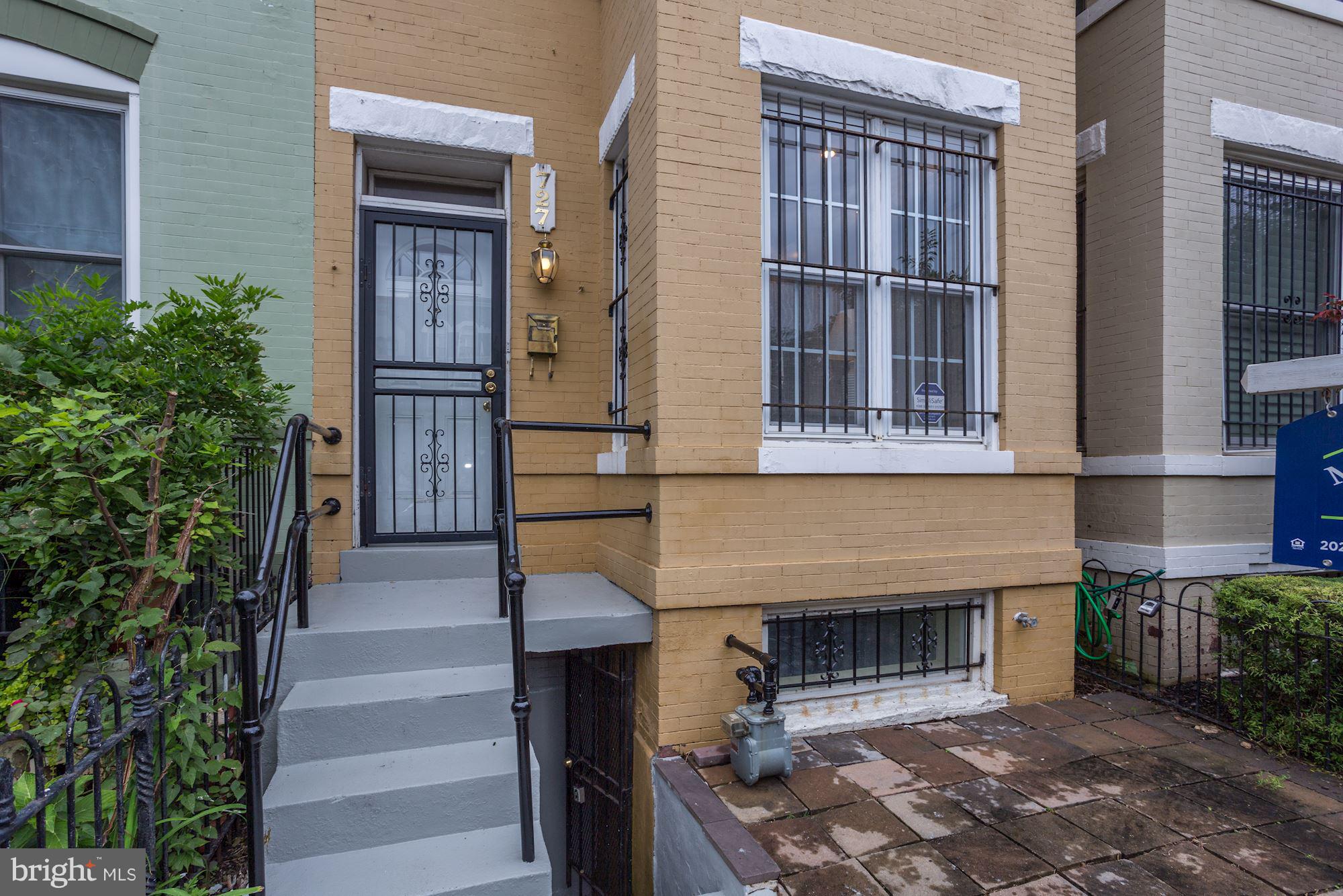 727 13th Street Northeast Washington, DC 20002 - Photo 2 of 27 a front view of a house with a garden