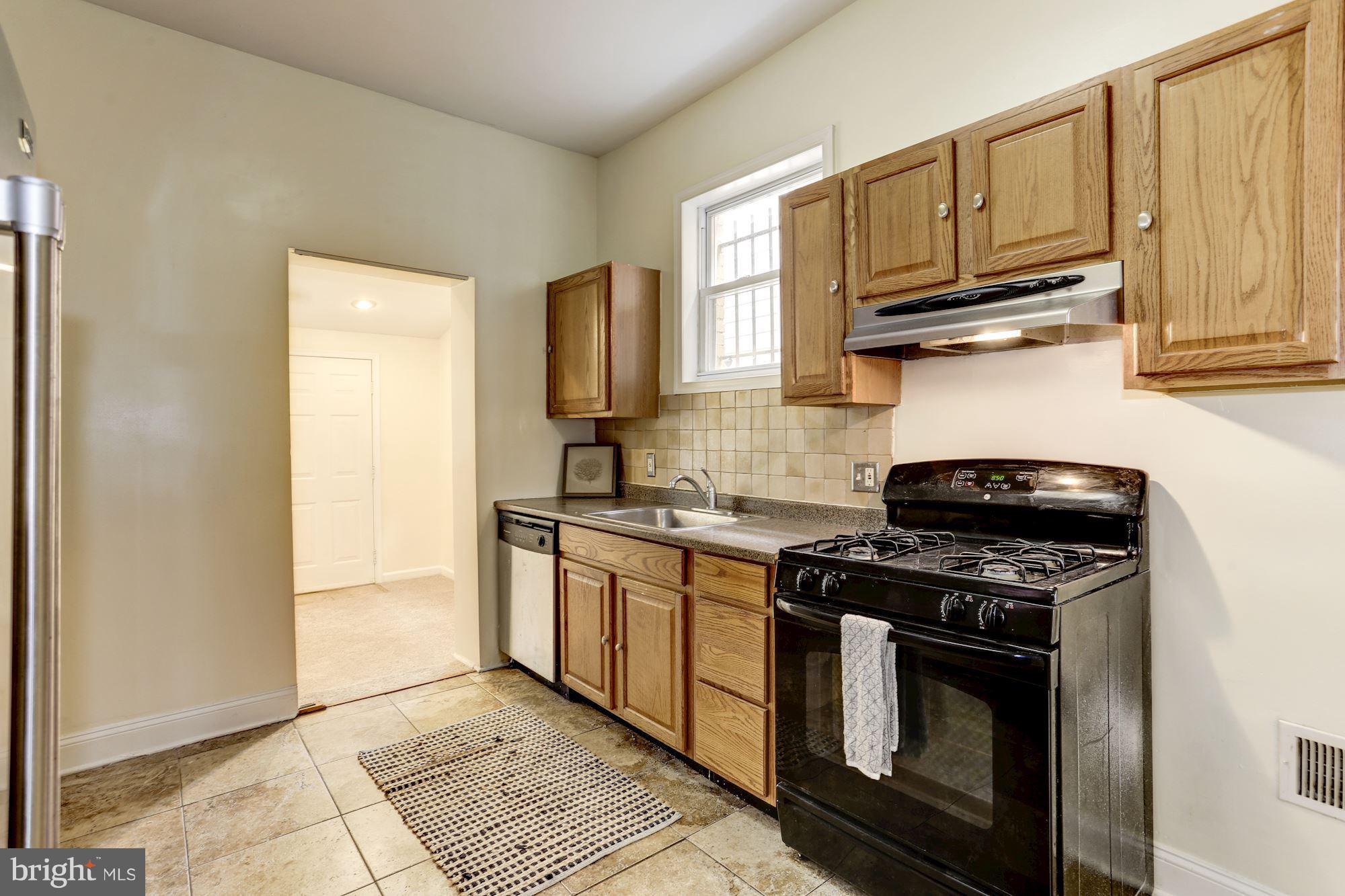 727 13th Street Northeast Washington, DC 20002 - Photo 11 of 27 a kitchen with stainless steel appliances granite countertop a stove a sink and a microwave