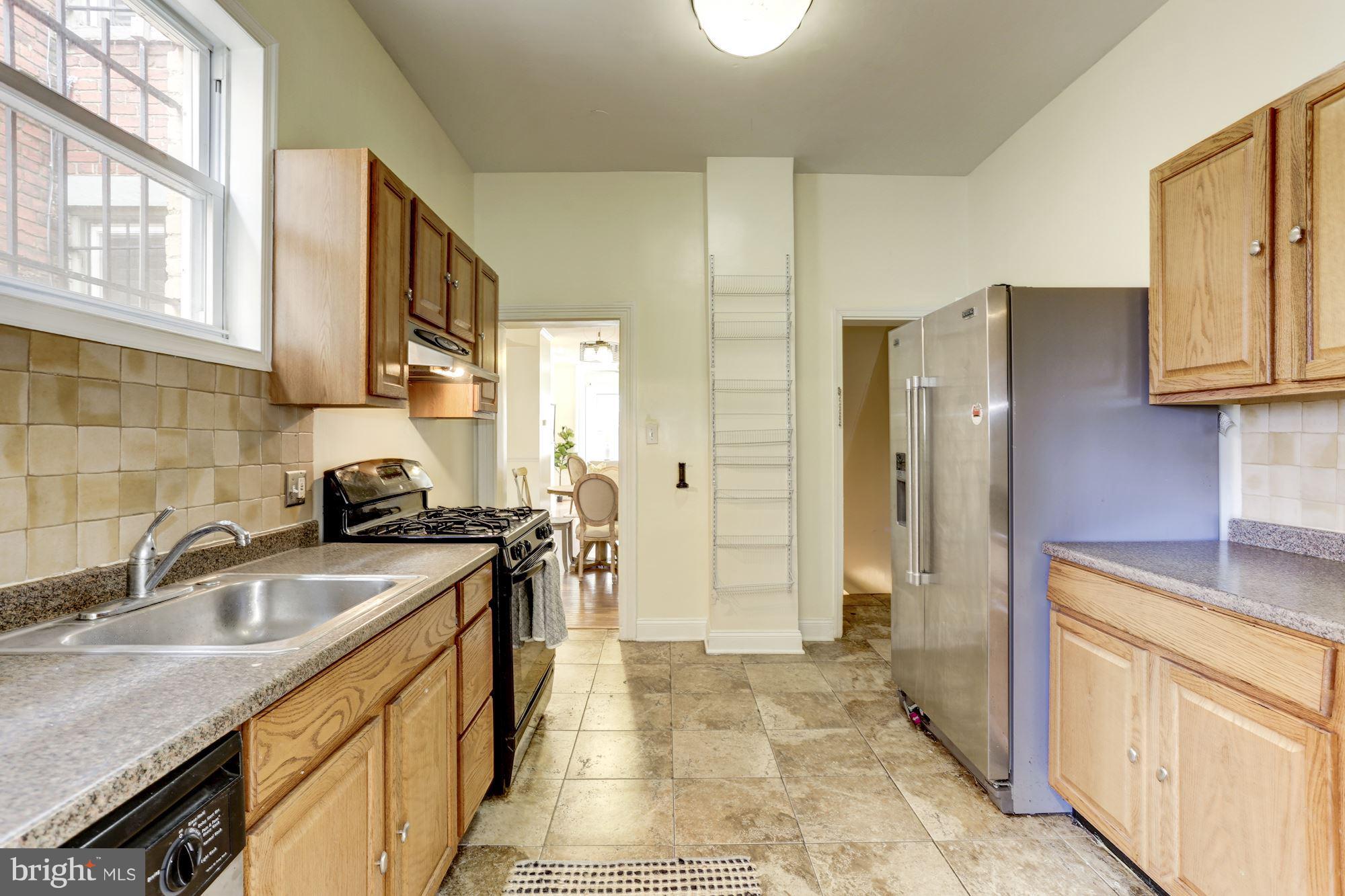 727 13th Street Northeast Washington, DC 20002 - Photo 13 of 27 a kitchen with a sink stove and refrigerator