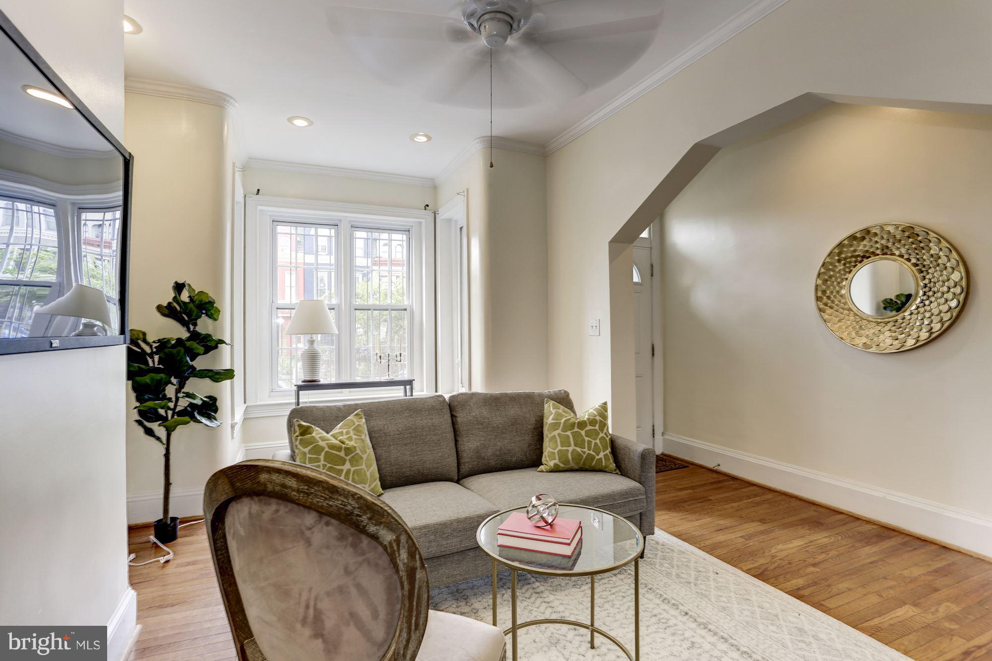 727 13th Street Northeast Washington, DC 20002 - Photo 6 of 27 a living room with furniture and a large window