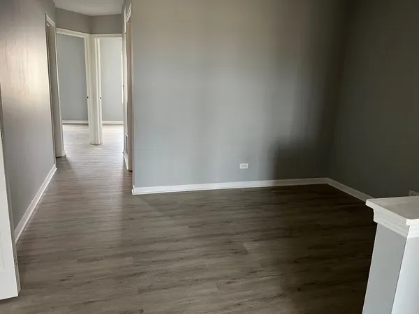 a view of a room with wooden floor