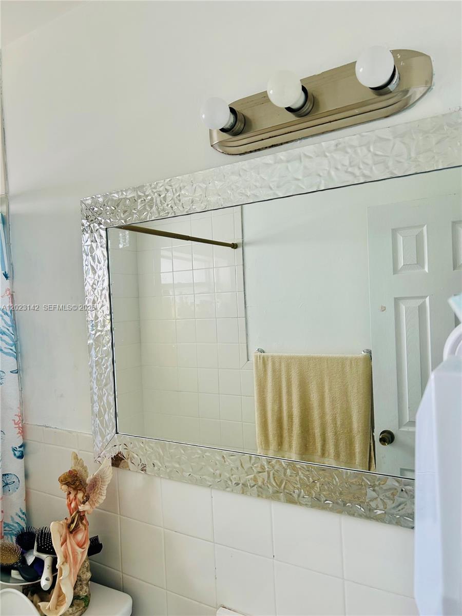 3410 Southwest 89th Court Miami, FL 33165 - Photo 12 of 18 a bathroom with a granite countertop sink and a mirror
