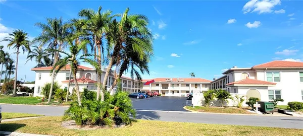 a front view of a building with a garden