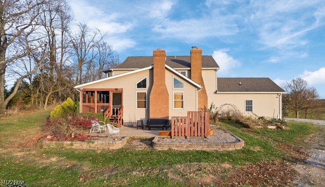 8995 Ridge Road Wooster, OH 44691 - Photo 37 of 50 Back of house with a chimney, a patio, and a yard