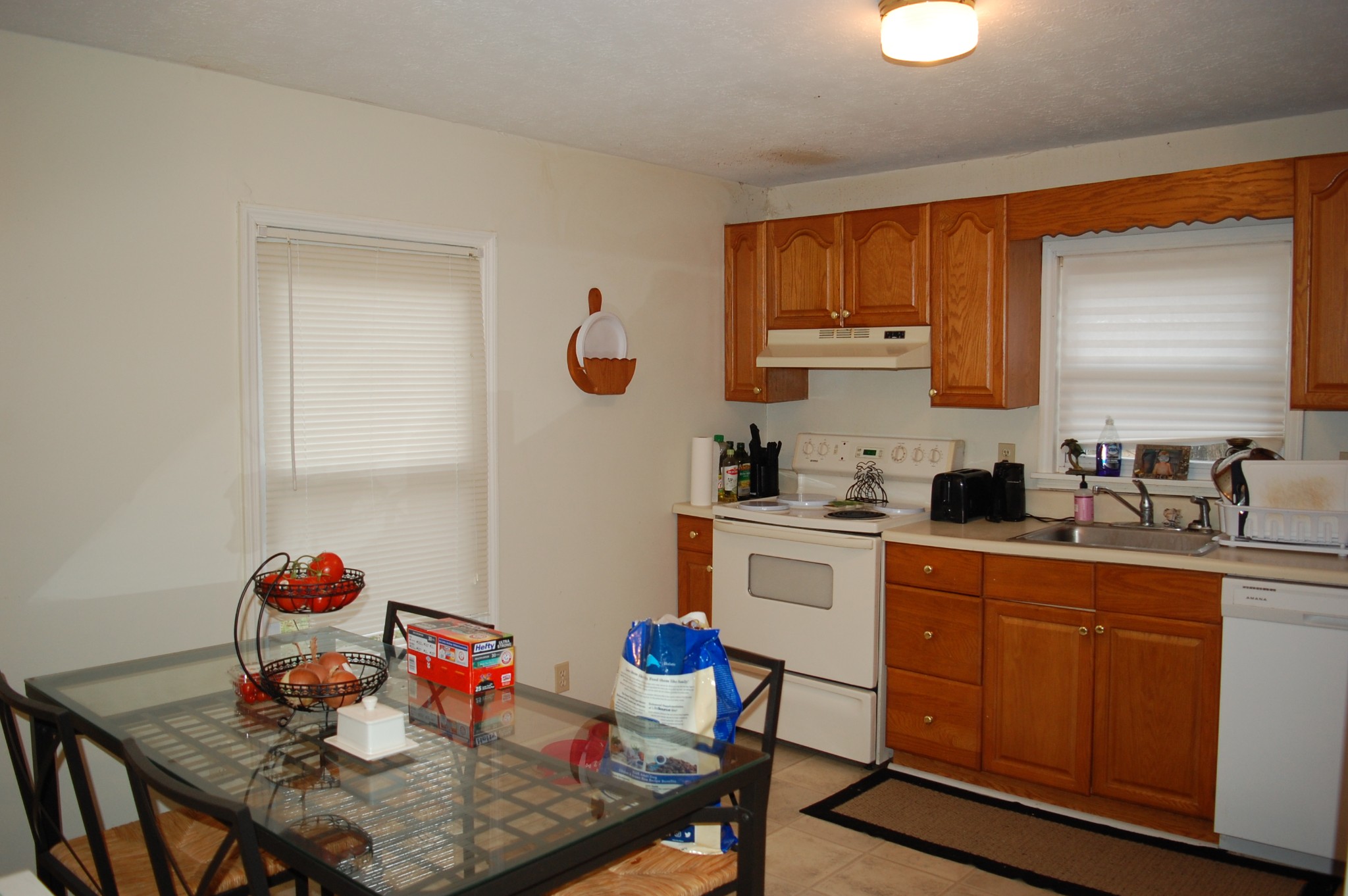 3301 Rossview Road Clarksville, TN 37043 - Photo 3 of 14 a kitchen with stainless steel appliances granite countertop a sink dishwasher and cabinets with wooden floor