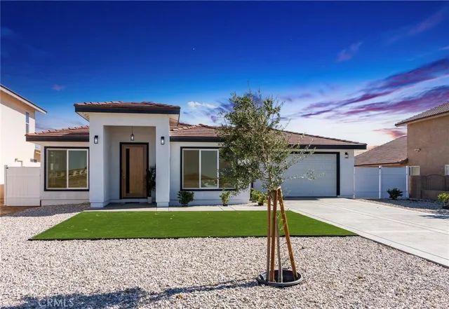 a view of a brick house with a yard