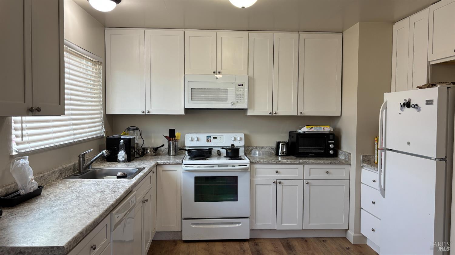 6120 Montecito Boulevard Santa Rosa, CA 95409 - Photo 13 of 17 a kitchen with cabinets appliances a sink and a window