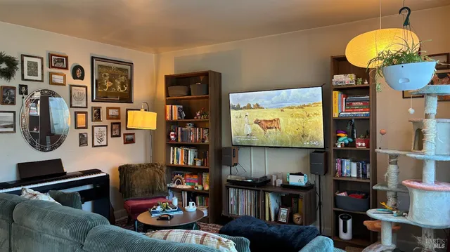 a living room with furniture and a flat screen tv