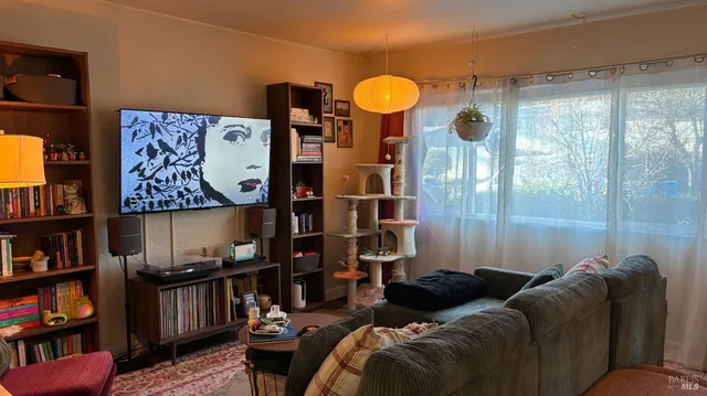 a living room with furniture cabinets and window