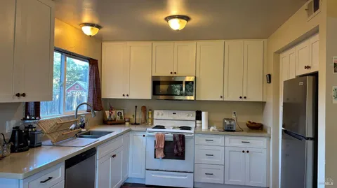 a kitchen with stainless steel appliances granite countertop a refrigerator sink and cabinets