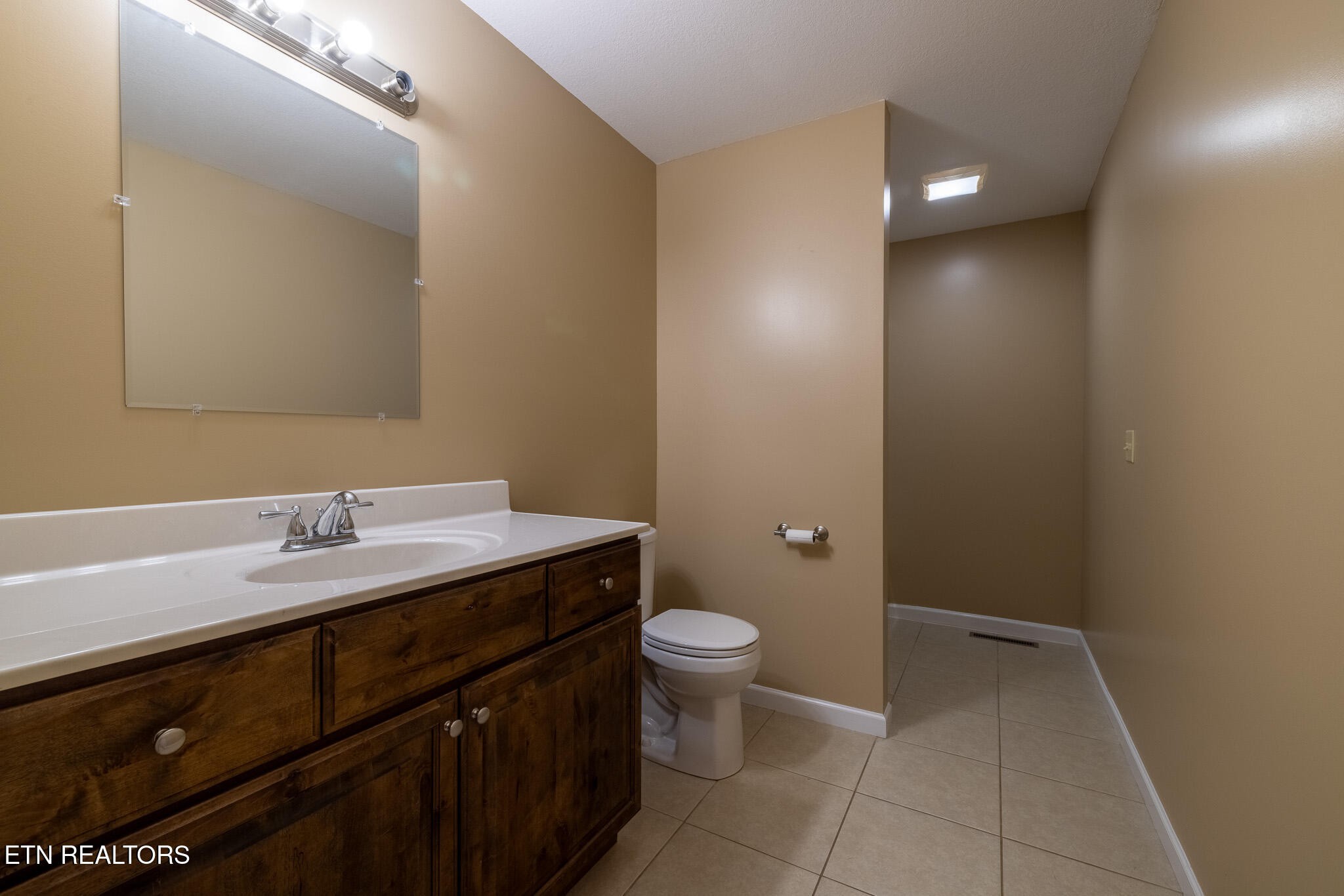 140 Washita Rutledge, TN 37861 - Photo 16 of 38 a bathroom with a granite countertop sink a toilet and a mirror