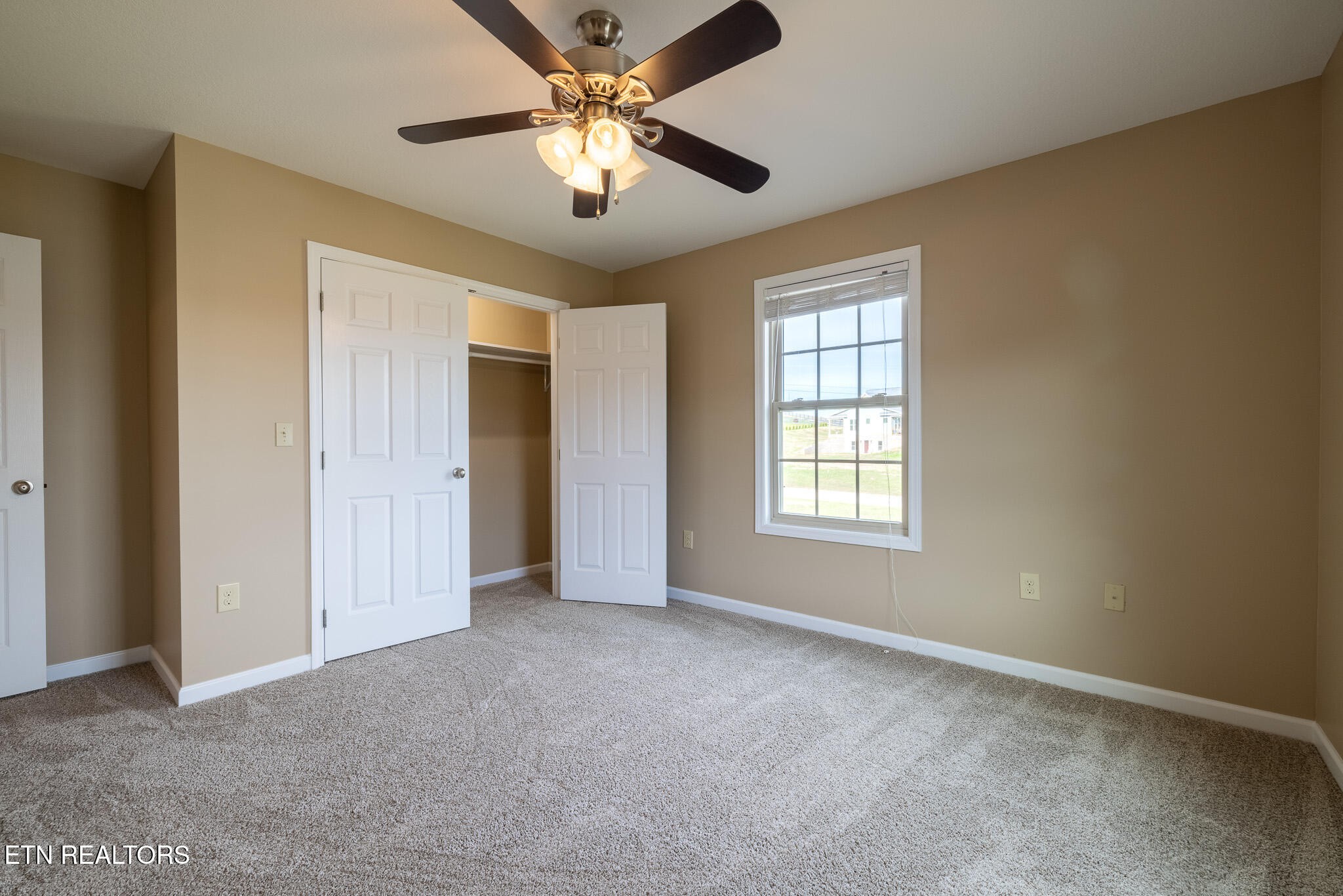 140 Washita Rutledge, TN 37861 - Photo 28 of 38 an empty room with chandelier fan and windows