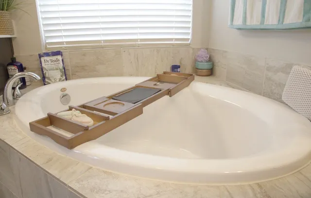 a bath tub sitting in a bathroom next to a sink