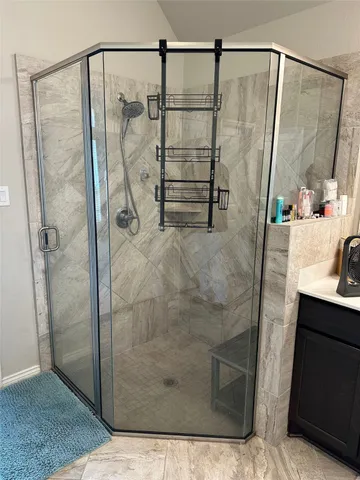 a bathroom with a shower and a sink