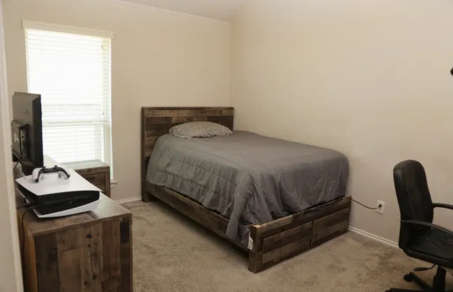 a bedroom with a bed and a chair