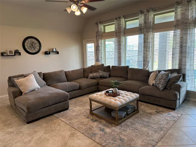 a living room with furniture and a large window